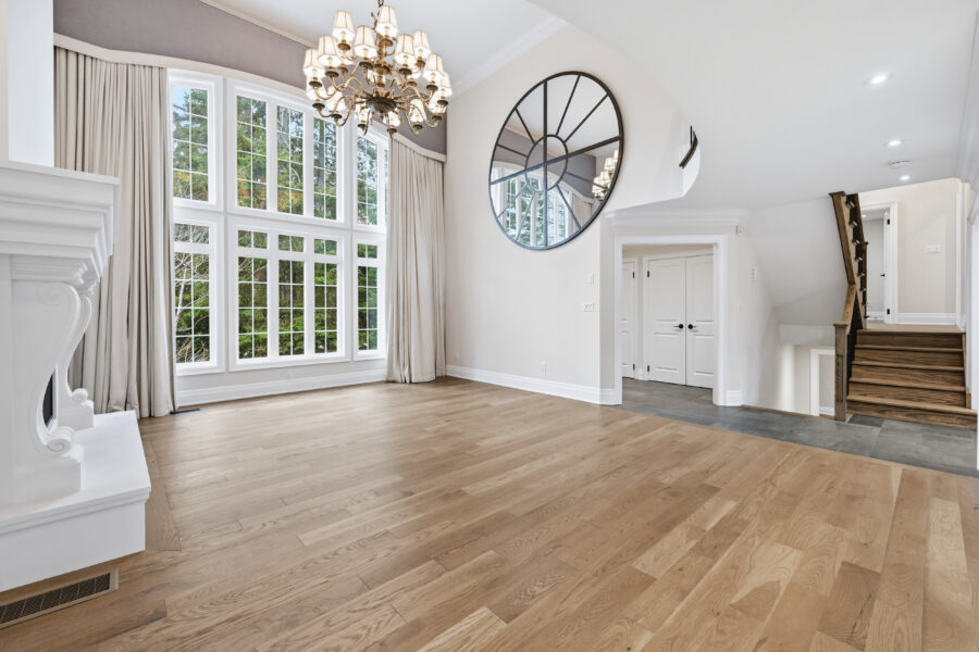 Grand living room at 1601 Venetia Drive Oakville with 17 foot ceilings and architectural window wall in Coronation Park