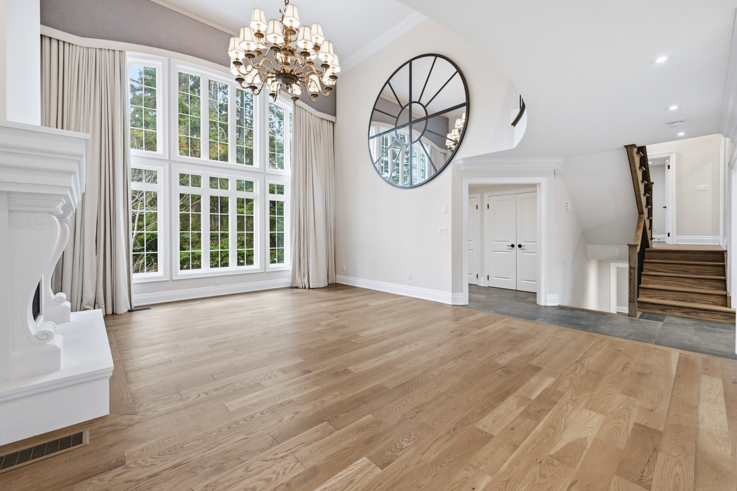 Grand living room at 1601 Venetia Drive Oakville with 17 foot ceilings and architectural window wall in Coronation Park